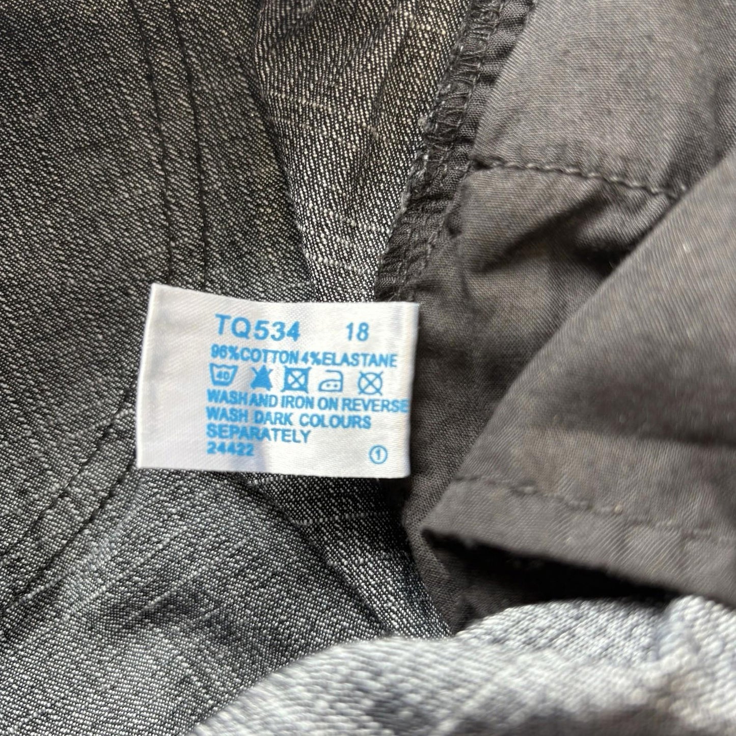 Clothing label on a gray fabric background