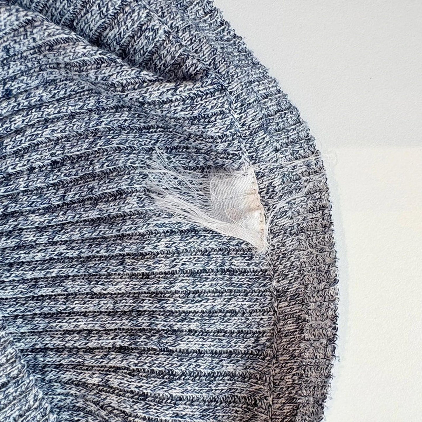 Close-up of a textured fabric with a visible label on a white background