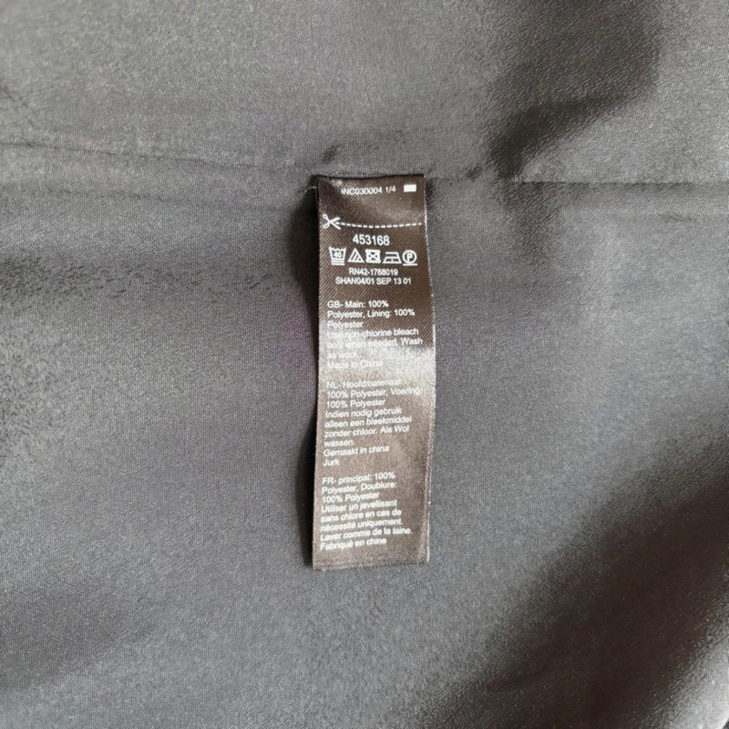 Clothing label on a gray fabric background