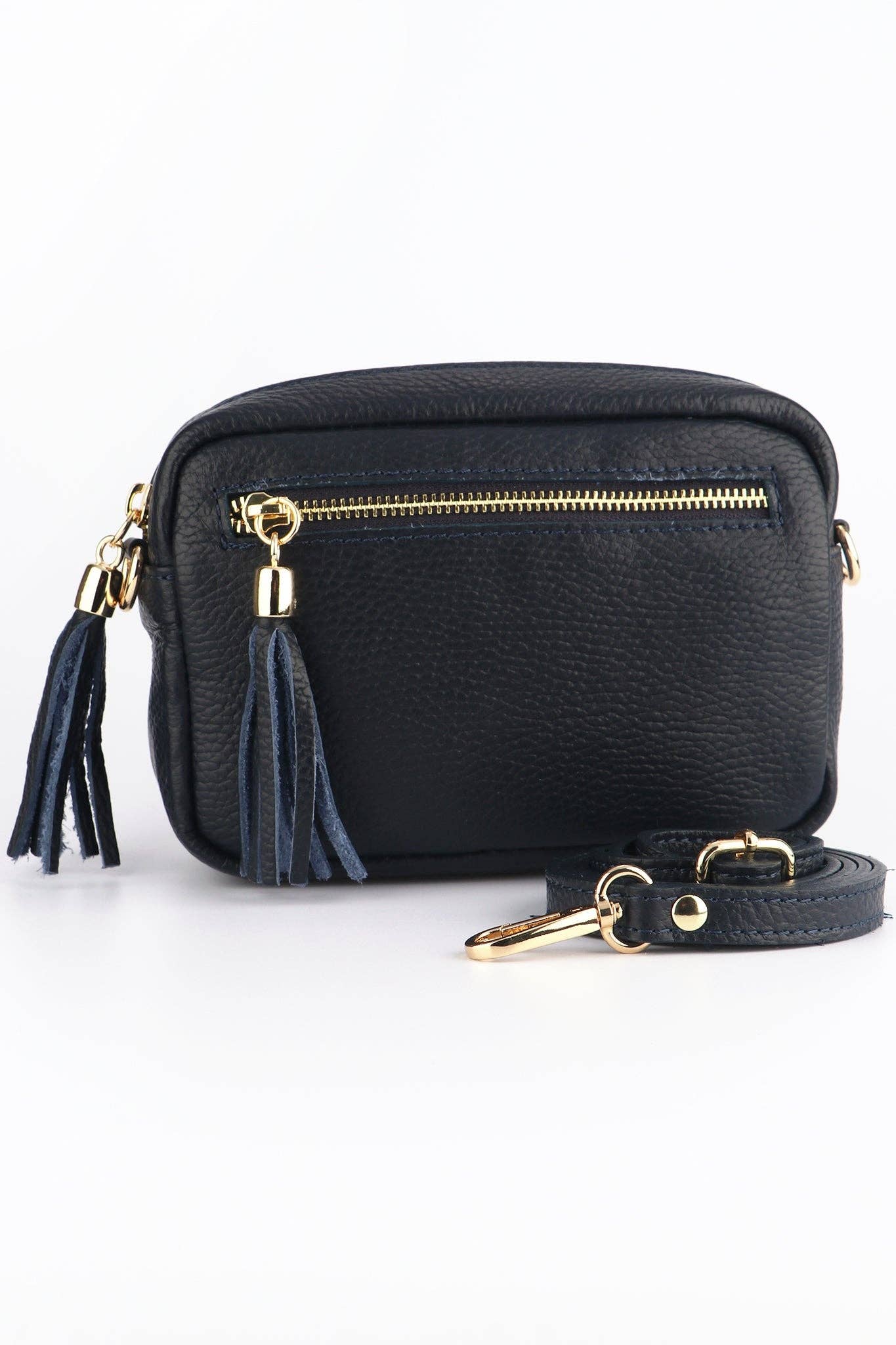 Black crossbody bag with gold accents and tassel on a white background