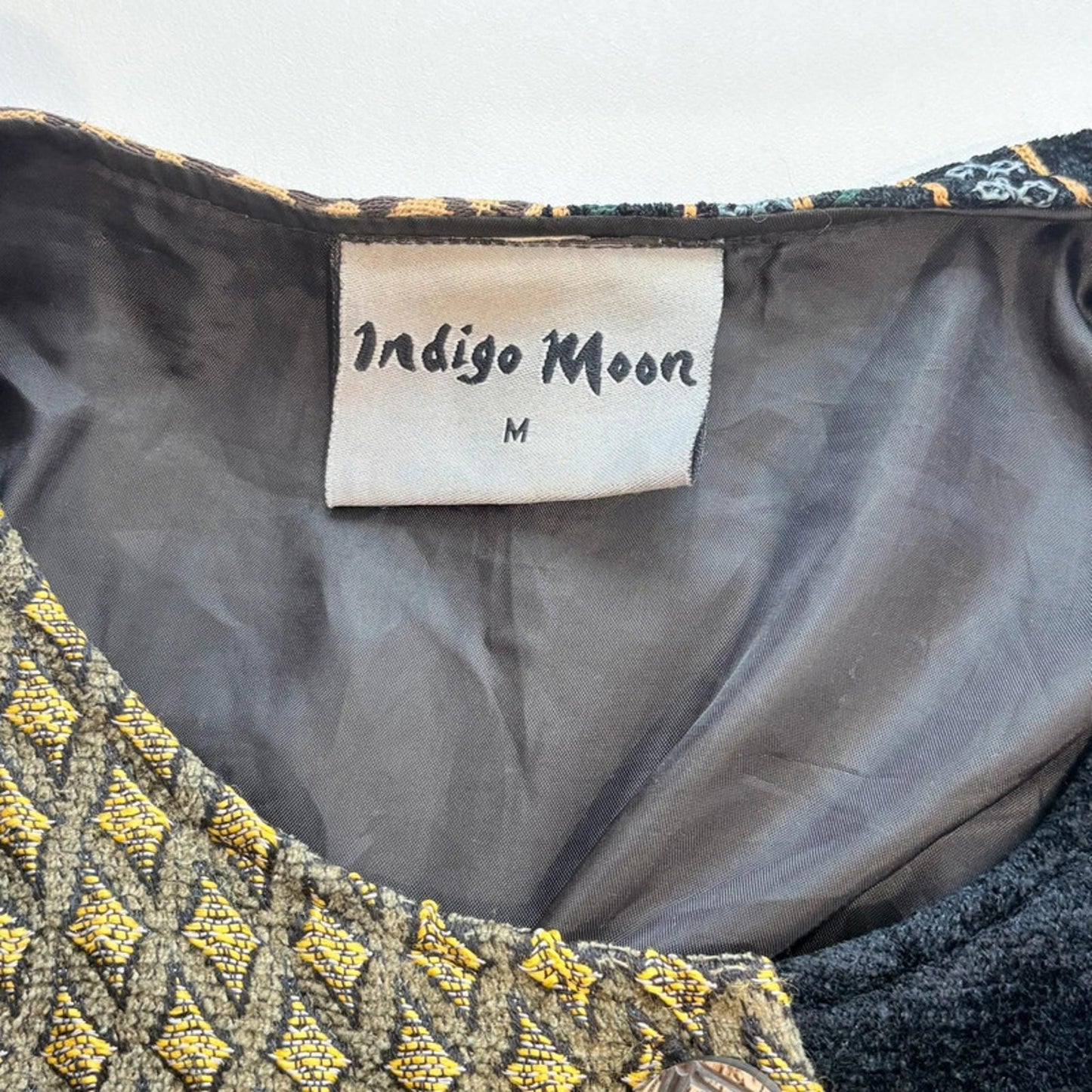Indigo Moon label on a garment with embroidered details