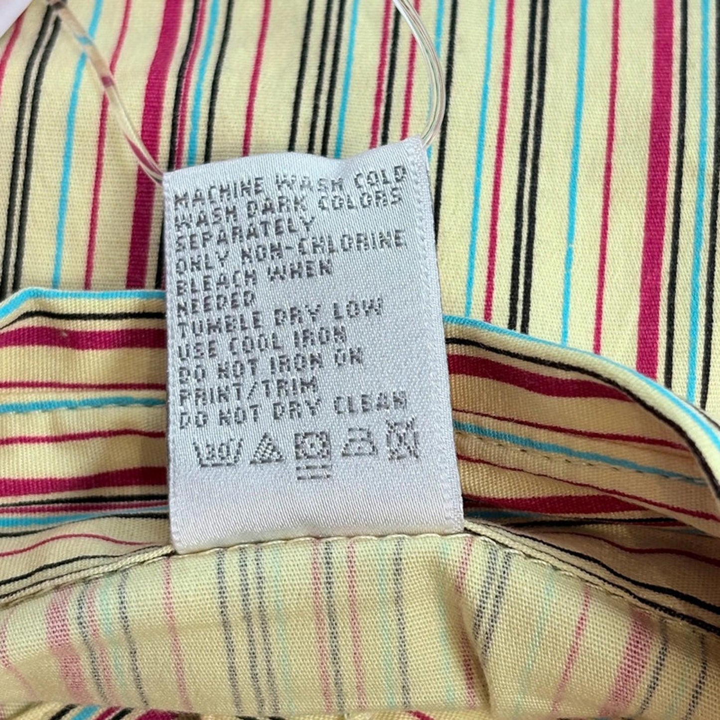 Fabric with care label on a multicolored striped Shirt