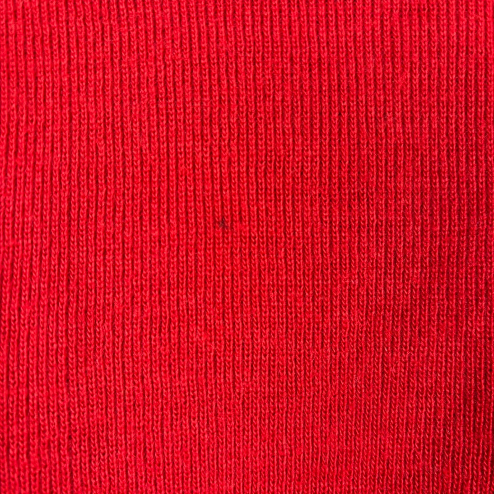 Close-up of red fabric texture showing a slight mark