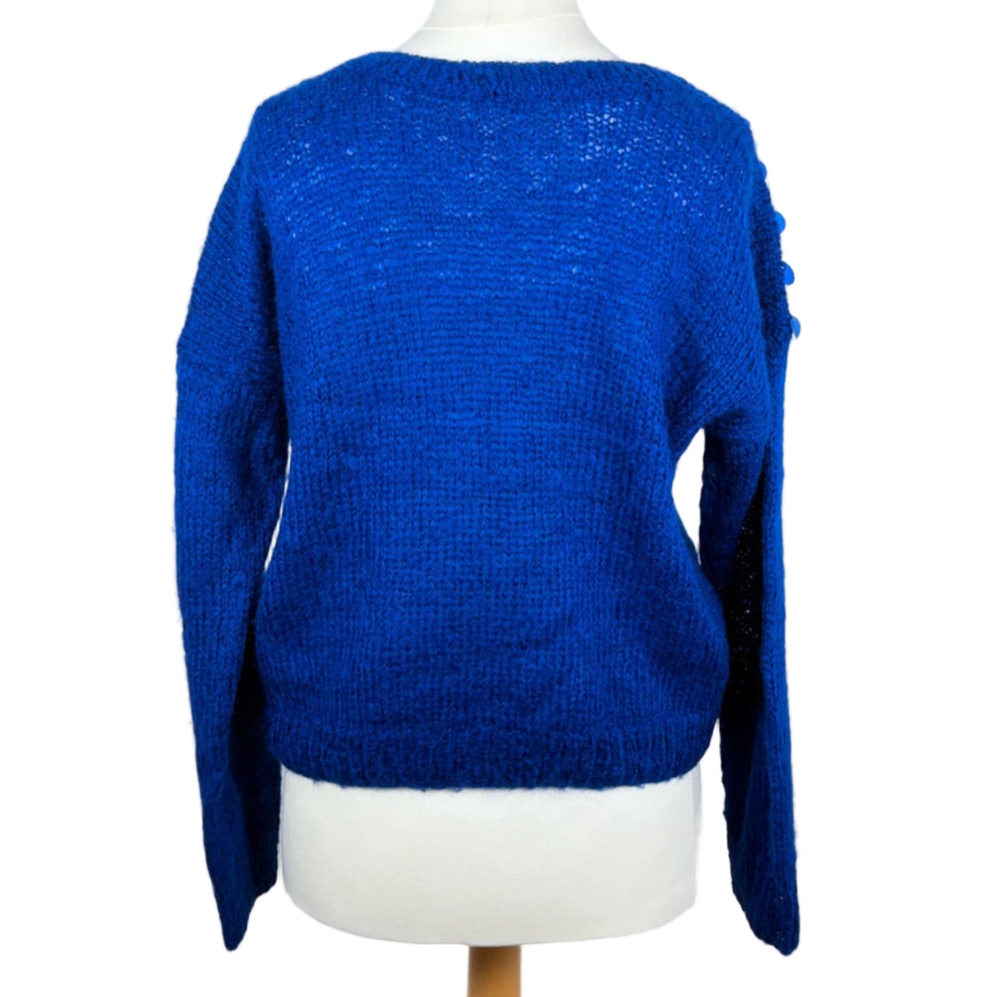 Blue sweater on a mannequin against a white background
