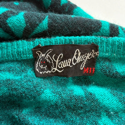Close-up of a teal and black checkered fabric with a label on a white background