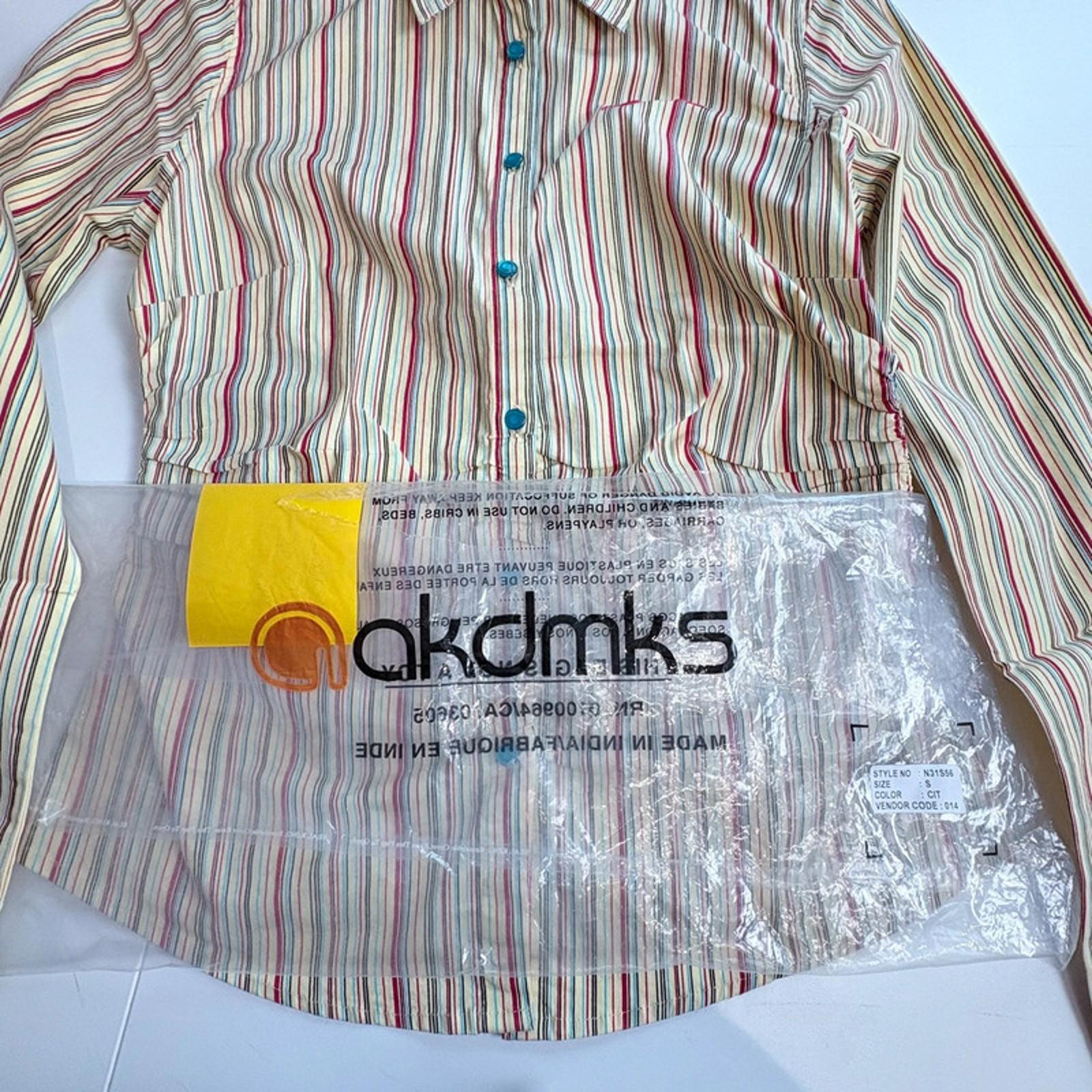 Striped shirt with a clear plastic bag displaying 'akdmks' branding on a white background