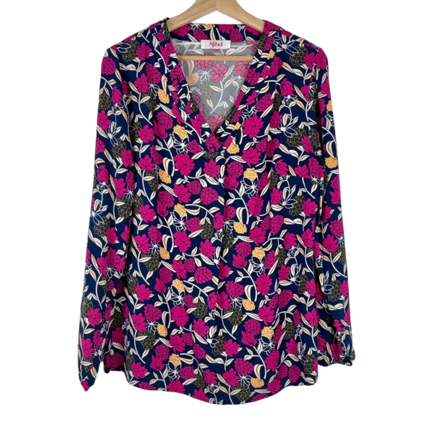 Floral patterned blouse on a hanger against a white background