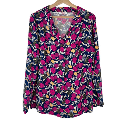 Floral patterned blouse on a hanger against a white background