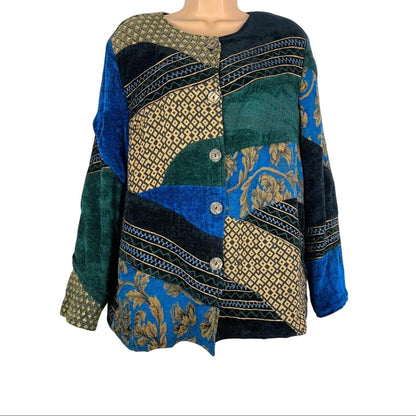 Mannequin wearing a colorful patchwork jacket with blue, green, and gold patterns on a white background.