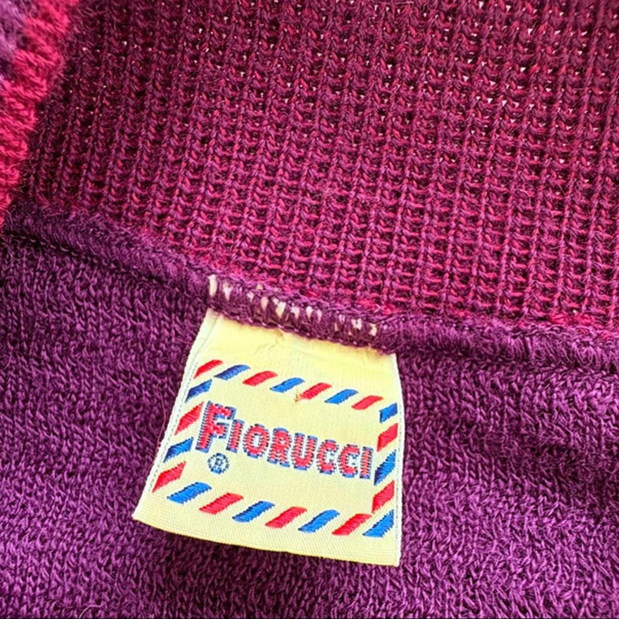 Close-up of a purple garment with a Fiorucci label.