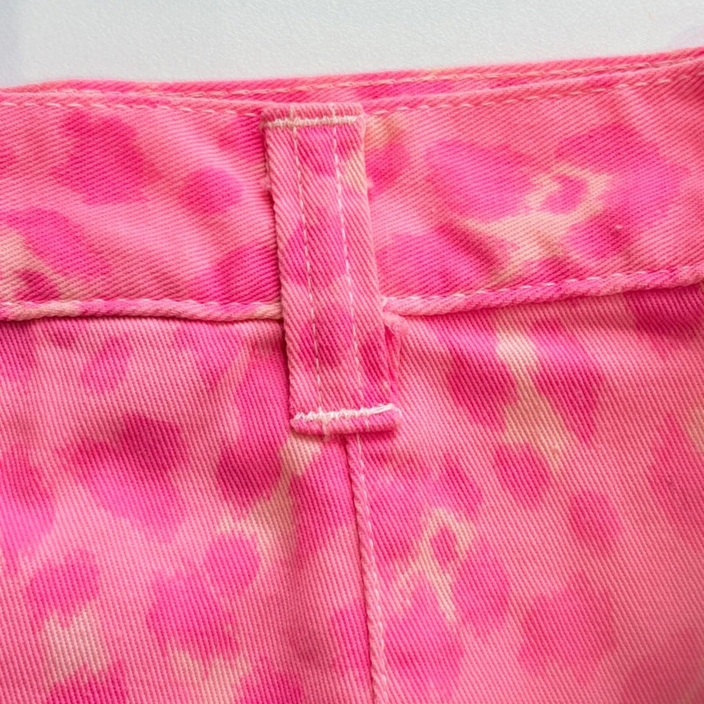 Close-up of pink camouflage fabric with a white background
