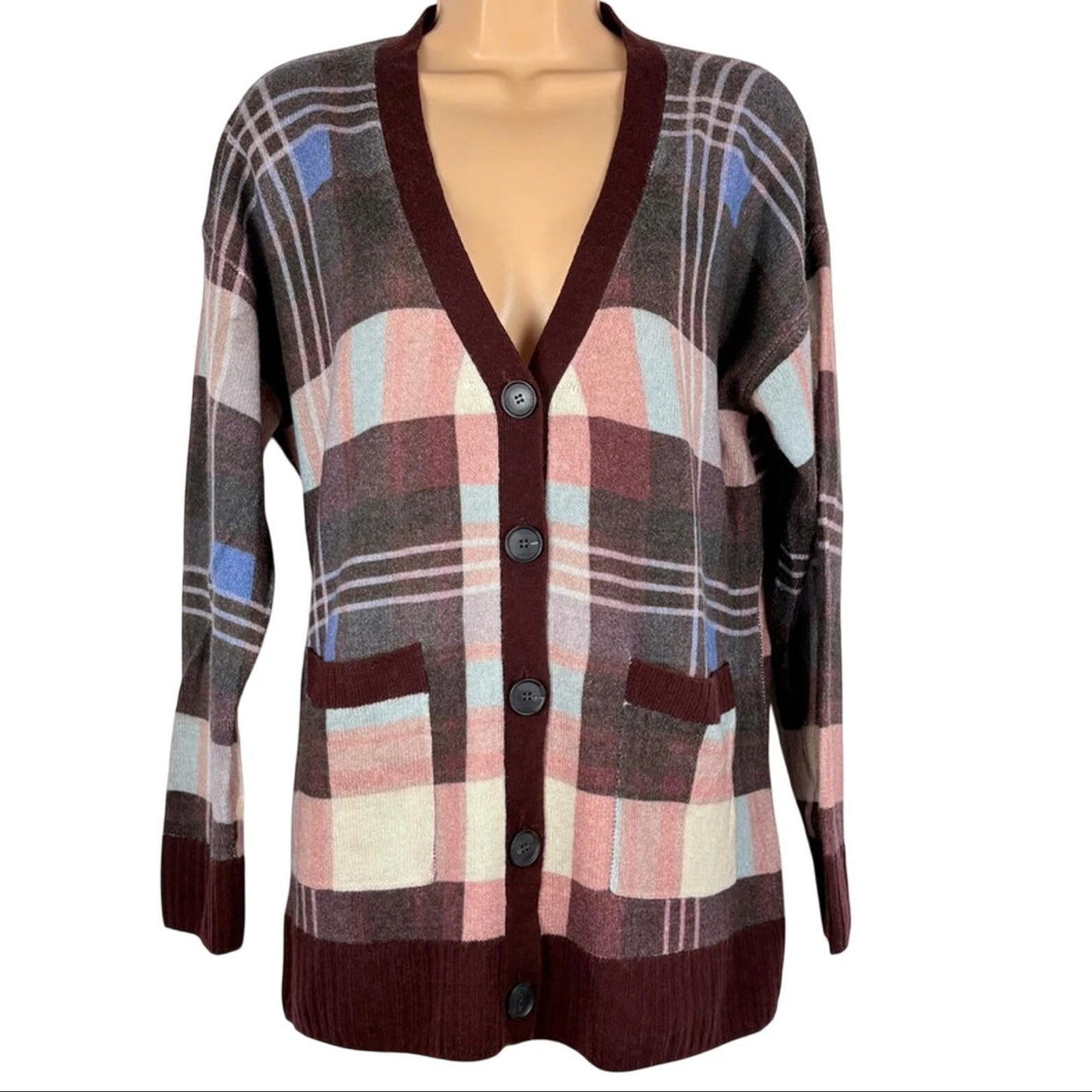 Plaid cardigan with buttons on a mannequin against a white background
