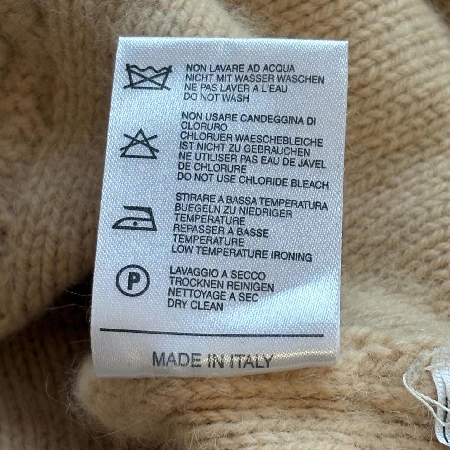 Clothing label with care instructions on a textured fabric background