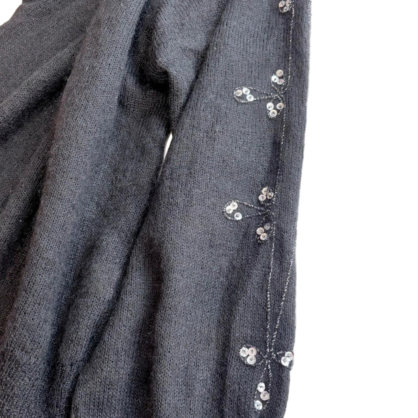 Black fabric with small white floral embellishments on a white background