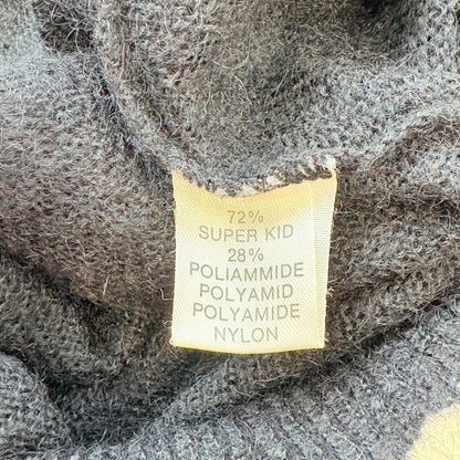 Fabric label on a textured fabric background with material composition details.