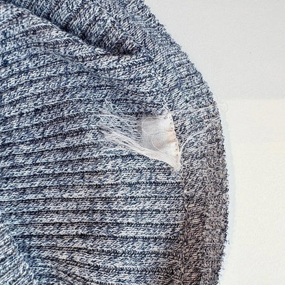 Close-up of a textured fabric with a visible label on a white background