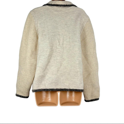 Beige jacket on a hanger against a plain background