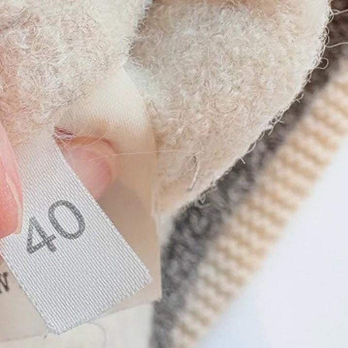 Fabric tag with size number 40 on a textured fabric background