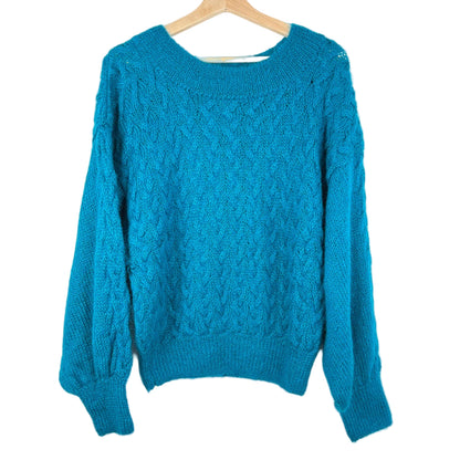 Blue sweater on a wooden hanger against a white background