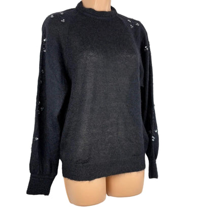 Black sweater on a mannequin against a white background