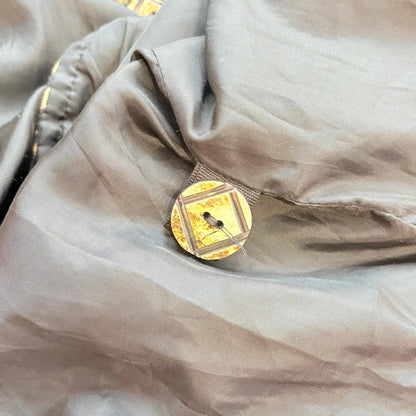 Close-up of a button on a beige fabric surface