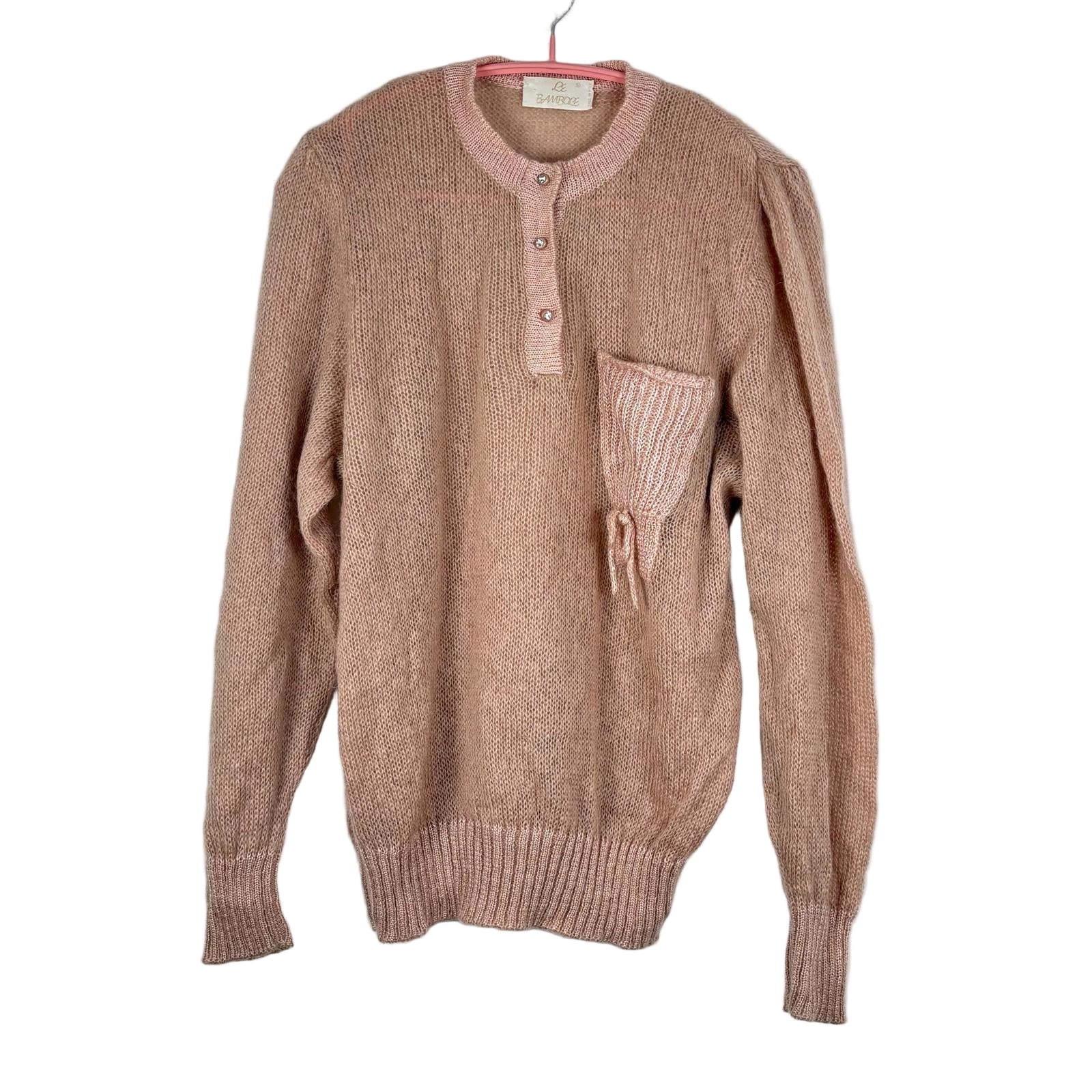 Pink sweater with a pocket on a white background