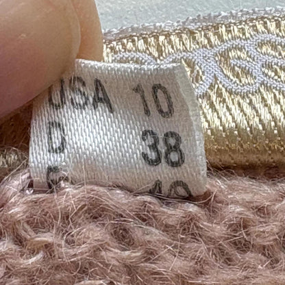 Close-up of a size label on a textured fabric background