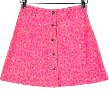 Pink skirt with a leopard print pattern on a hanger against a white background