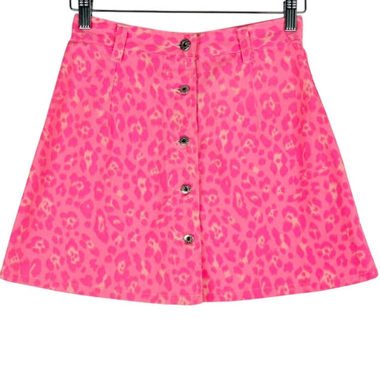 Pink skirt with a leopard print pattern on a hanger against a white background