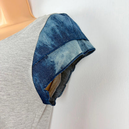 Mannequin wearing a gray shirt with a blue denim collar against a white background