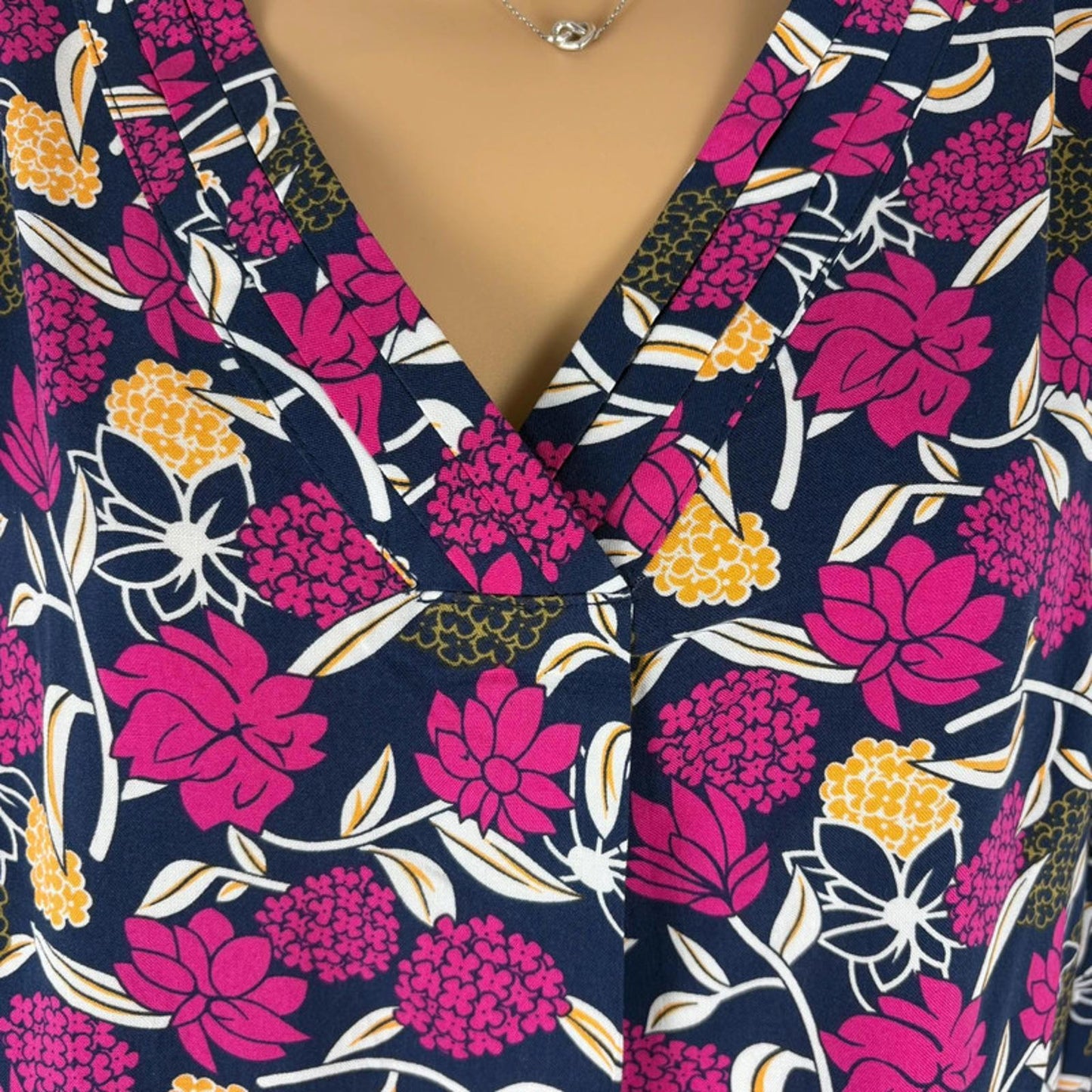 Floral patterned fabric with pink, yellow, and white flowers.