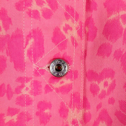 Close-up of a pink floral shirt with a button