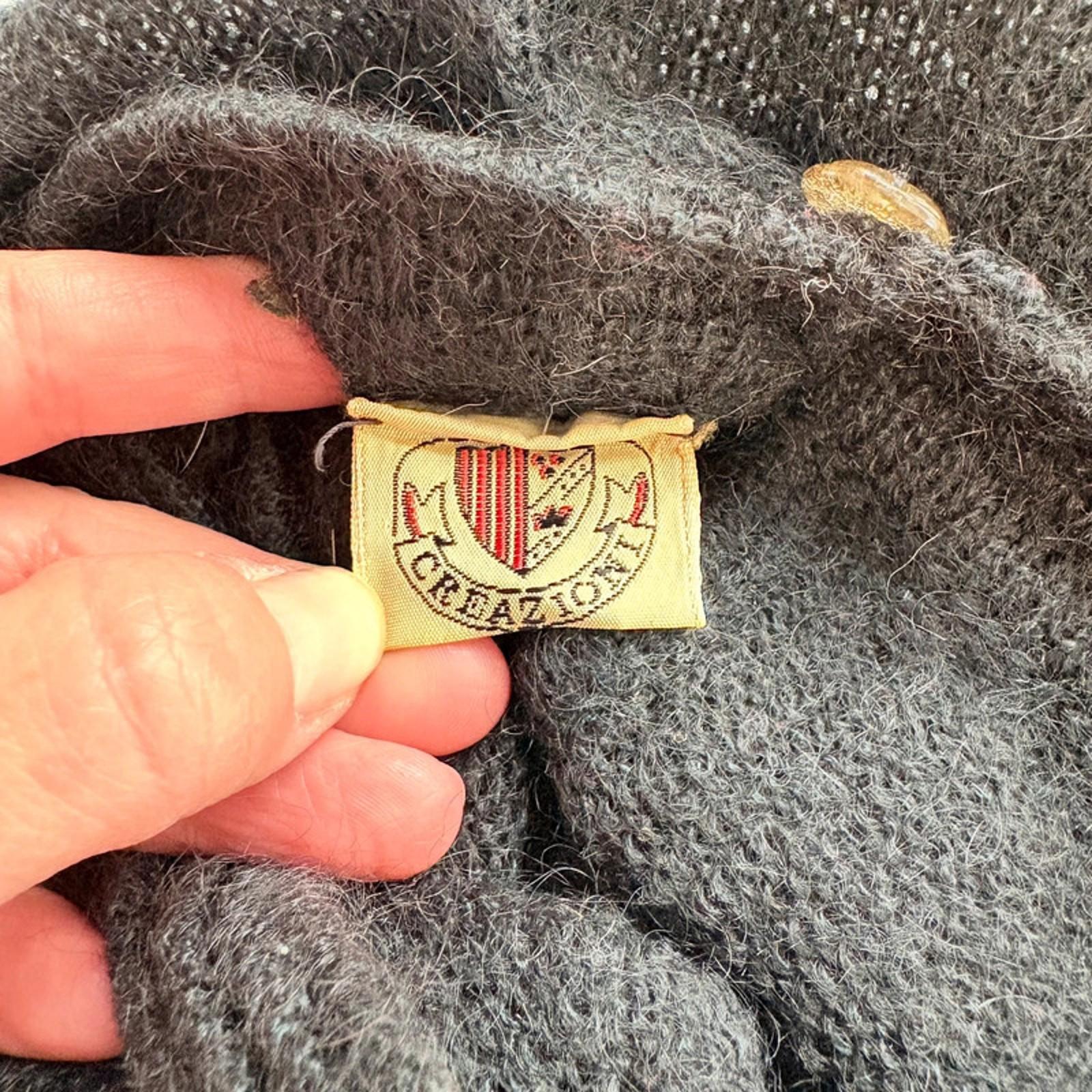 Close-up of a label  with a hand holding it.