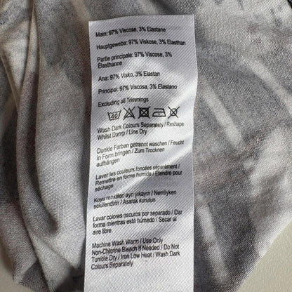 Clothing label with text and symbols on a fabric background