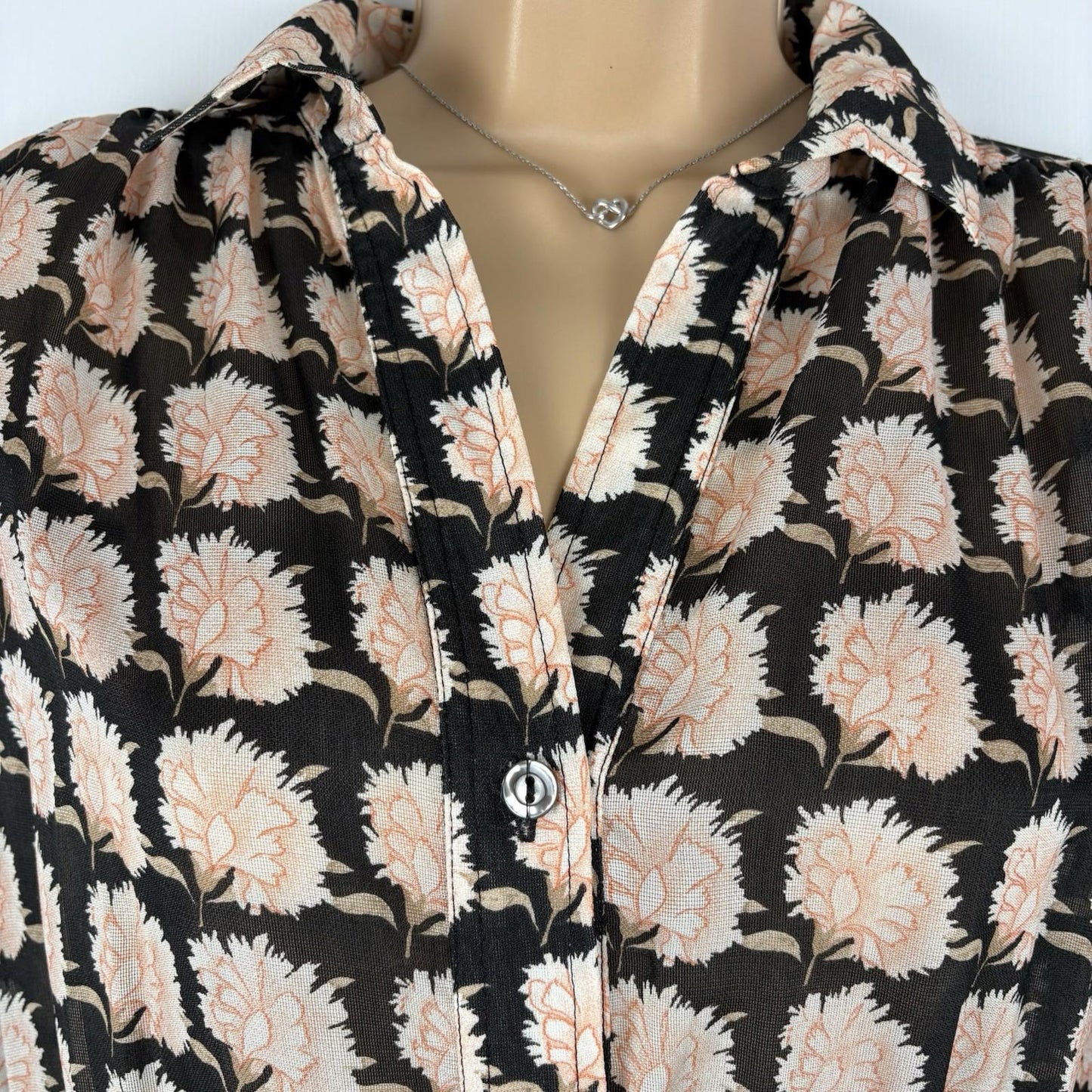 Floral patterned shirt on a mannequin with a neutral background