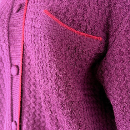 Close-up of a purple textured garment with a red trim