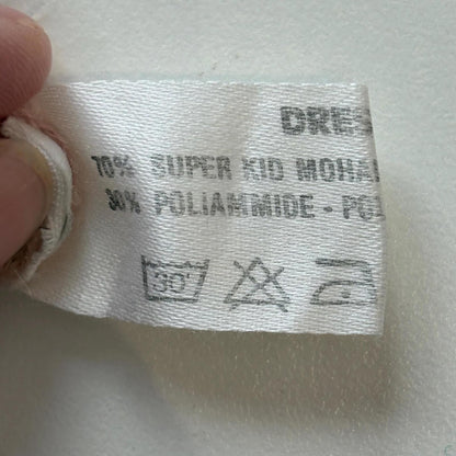 Clothing label with fabric composition and care instructions on a white background