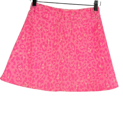 Pink skirt with a subtle pattern on a hanger against a white background