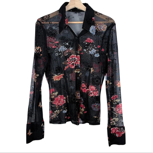 Floral patterned shirt on a hanger against a white background