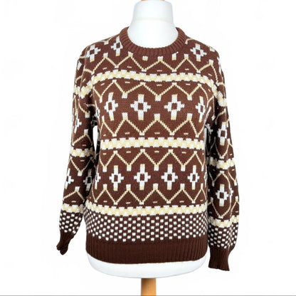 Brown sweater with white geometric pattern on a mannequin against a white background
