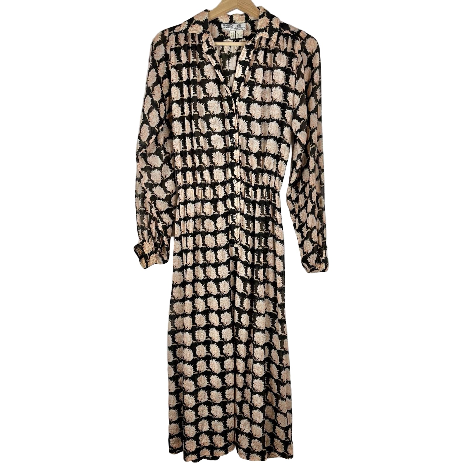 Patterned dress on a hanger against a white background