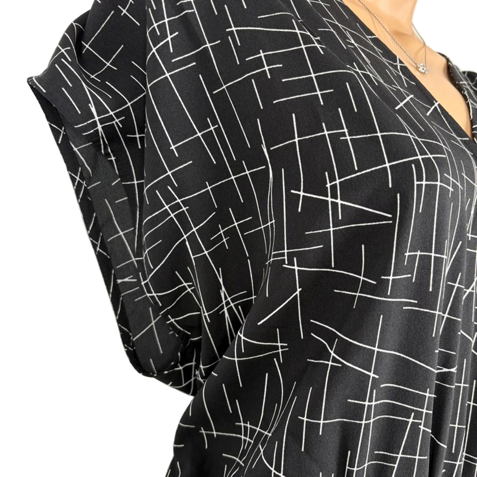 Black dress with white geometric pattern on a white background