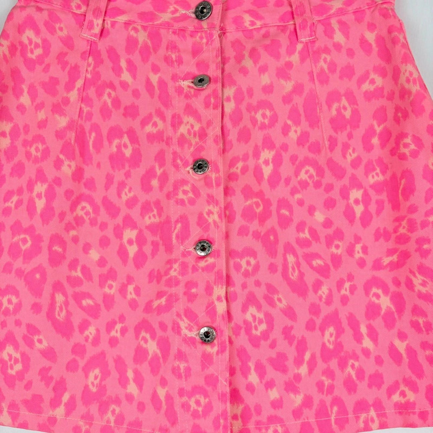 Pink shirt with leopard print and buttons on a white background