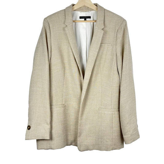 Beige blazer on a hanger against a white background