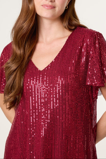 Red sequin top on a model