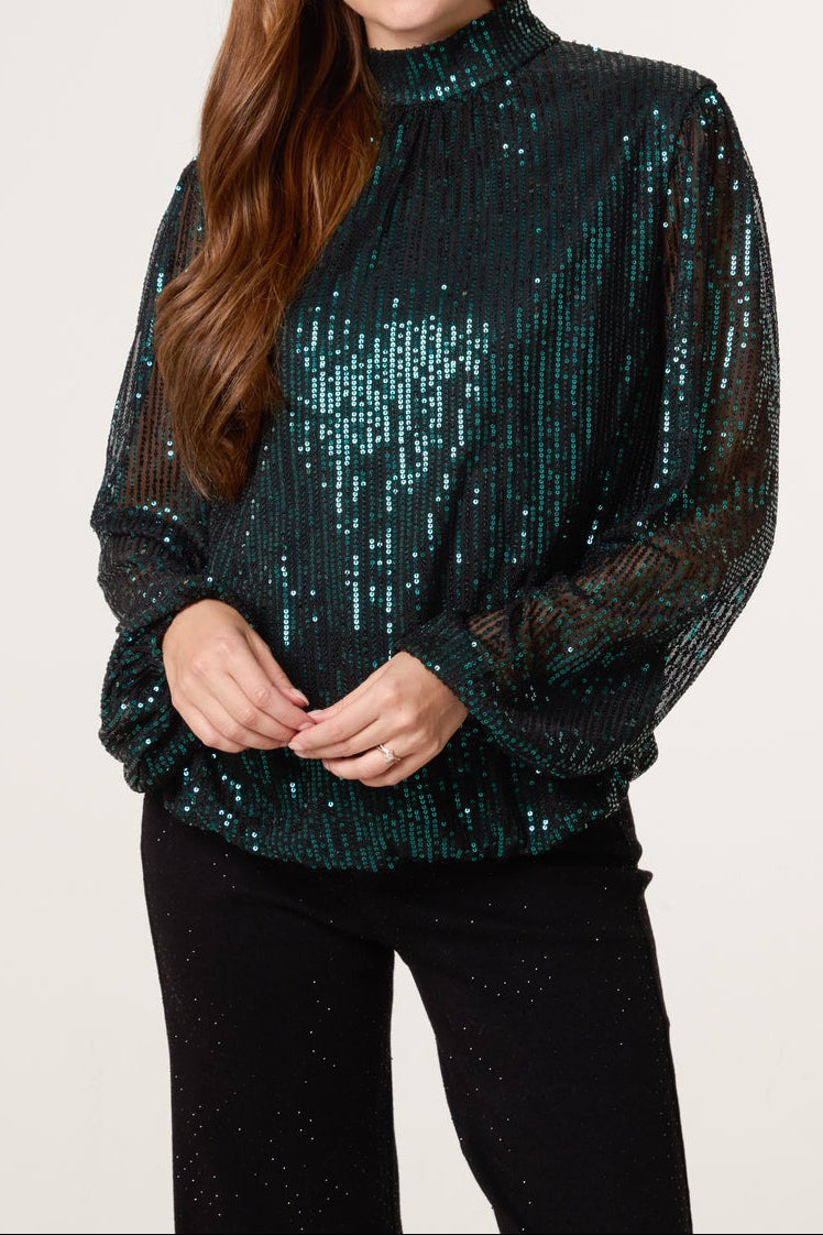 Green sequin top on a model 