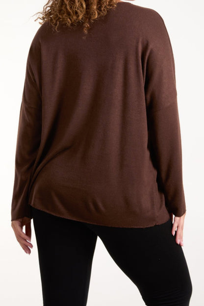 Brown sweater worn by a person on a white background