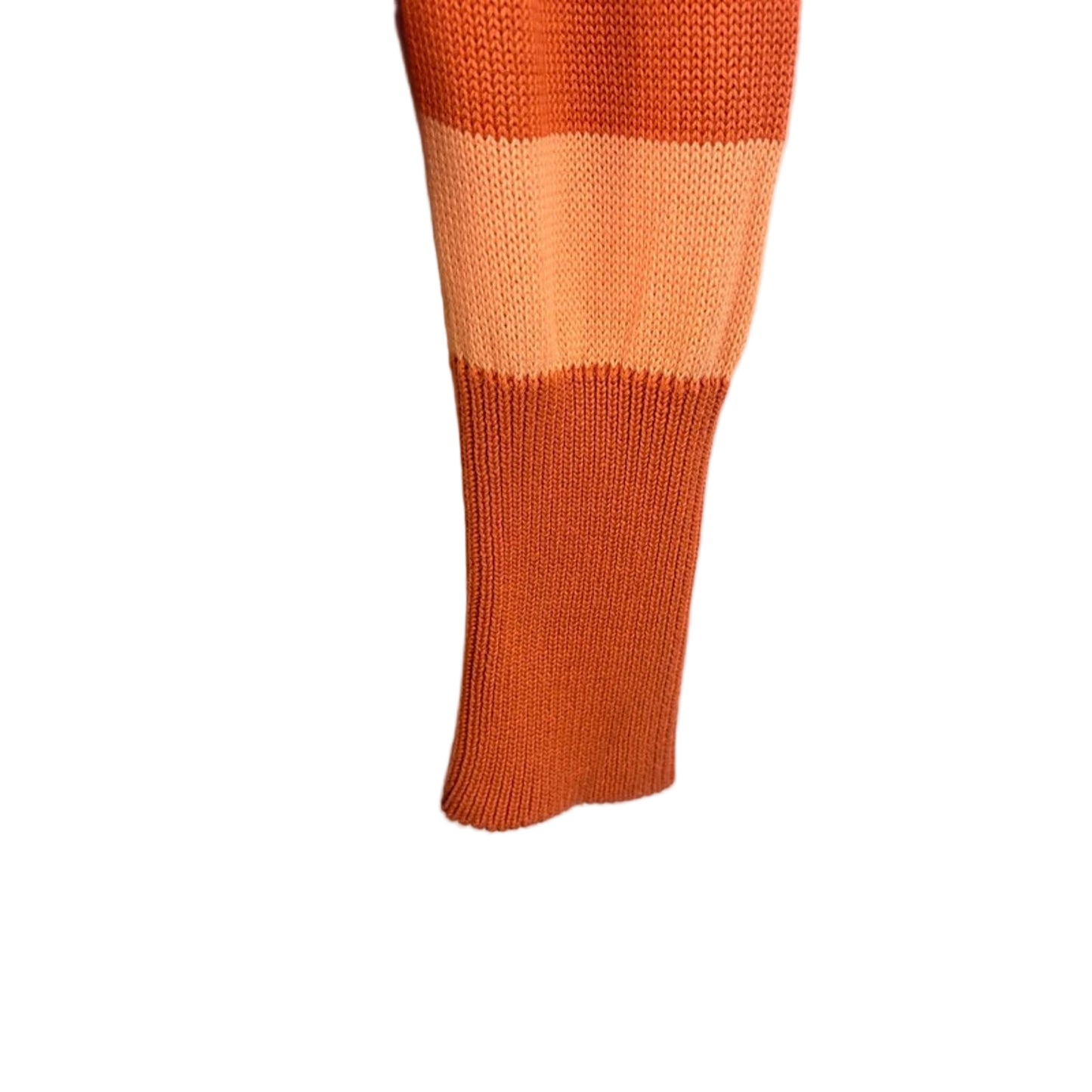 Close-up of an orange striped sweater sleeve on a light background