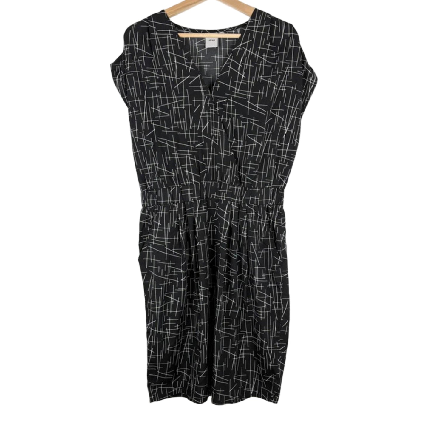 Black dress with white geometric pattern on a hanger against a white background