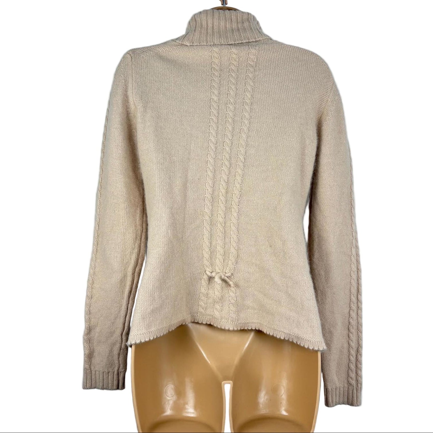Beige sweater on a mannequin against a white background